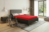 Bedroom with a wheelchair user mattress, wheelchair, and nightstands.