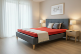 Modern bedroom with a gray bed frame, red blanket, and wooden nightstands.