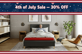 Man lying on a bed in a modern bedroom with a 4th of July sale banner at the top.