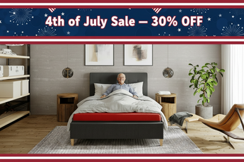 Man lying on a bed in a modern bedroom with a 4th of July sale banner at the top.