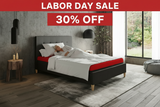 Modern bedroom with a bed featuring a red mattress and gray frame.